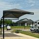 covered paved RV site with clubhouse in the background at The Hill Top