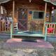 High-resolution photo of a decorated cabin front/porch — useful for showing cabin accommodations; found on the site's amenities/gallery pages.