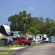 Linear view down an RV lane showing parked RVs, hookups and roadway — good representation of typical RV sites and layout (gallery).
