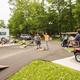 Daytime scene of a group enjoying campground activities (cornhole, picnic areas, RVs visible) — shows community/amenity space and recreation typical of the KOA property; sourced from the site’s groups/activities images.
