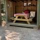 Covered picnic shelter with a picnic table and gear—depicts on-site campsite amenities and dining/food-preparation area; appears in the site’s gallery pages.