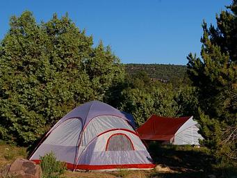 Two tents in a camp site.