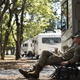 Man in military uniform relaxing outside his RV at Lost River RV Park, a military and workforce friendly campground