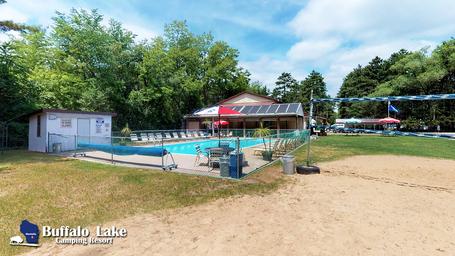 Outdoor pool and surrounding area with resort branding watermark — shows on-site swimming facility and layout useful for guests.