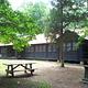 A picnic table under the shade of trees on the grounds of Cabin Camp 3 