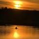 Sunset over the lake with a kayaker — strong scenic image demonstrating recreational activities on the campground’s lake. Image is hosted on the campground’s site.
