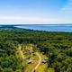 Bird's eye view of seasonal RV site with lake in distance