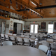 Interior photo of the clubhouse/event room showing seating and facility space — useful to illustrate indoor community amenities available to guests (source: Portfolio page).