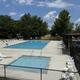 Clear view of the campsite swimming pool area with lounge chairs and covered seating — useful facility photo that appears to be on the resort property.