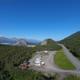 Clear aerial overview of the entire Grand View RV Park property showing RV stalls, buildings (restaurant/office), access road and surrounding landscape — matches homepage hero image and establishes site layout and setting.