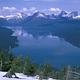 Lake McDonald surrounded by snow covered peaks.