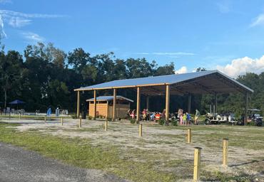 Large covered pavilion with people and adjacent grounds visible — shows an on-site gathering/activity facility used by the resort (page gallery context).