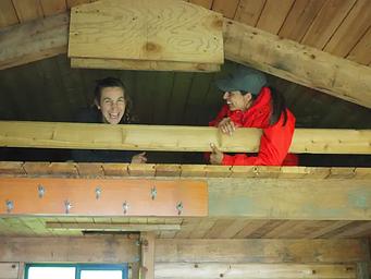 Two people in the cabin loft laughing
