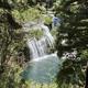 A beautiful waterfall in a forested area, near Trailin RV Park and Campground.