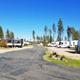 Wide-angle overview of the RV park showing multiple RVs, paved roadway and landscaping — good general property shot (file appears on the site’s RV park gallery page).