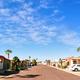 Clear exterior streetscape showing rows of RV/mobile home sites, palms and paved road — establishes overall layout of Capri RV Resort (image hosted on the Capri RV Resort page).