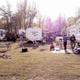 Well-framed view of multiple RVs and picnic areas among trees showing typical wooded/shady RV sites; comes from the campground’s photo gallery (Whitetail Ridge Campground Photos).