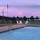 Swimming pool with seating and a view toward the water/landscape — shows on-site pool amenity and nearby waterfront scenery; from the campground amenities page.