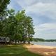 Aerial view of the resort’s waterfront clubhouse, docks and lawn — good overall overview of the property layout. Image appears on the resort’s main page banner (page: Lake Gaston RV Camping | Thousand Trails RV Campground, URL provided).