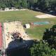 Aerial/upper-level view of recreation fields, playground and courts with surrounding campsites — provides an overview of grounds layout and multiple amenities.