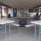 Covered pavilion photo with picnic tables and rocking chairs — highlights a communal amenity available to guests (Amenities page).