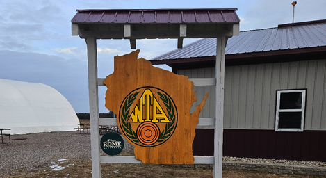 Ground-level photo showing the property sign and a building/structure on site (entrance/amenity area) — useful for identifying the venue and facilities (from the Latest Updates page).