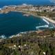 Aerial drone view showing the coastline and the campground area with tents and grounds — provides a clear overall site layout and setting (source page MG_ColdPlunge_Drone image on the property homepage).