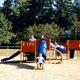 Playground structure with kids — useful for showing on-site recreational amenities; sourced from the campground gallery.