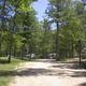 Wide view of a campground lane with trees and multiple sites visible — useful overall scene of the campground layout and setting, from the Campground Map page.