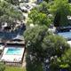 Aerial view showing overall park layout: pool, clubhouse, RV sites and tree canopy — useful overview photo (site background/hero on the property pages).