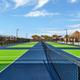 Image of multiple bright green/blue pickleball/tennis courts on-site—useful amenity shot from the Gallery confirming on-property courts.