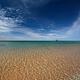 View of the beach and Morazan Shipwreck in the distance under a blue sky from South Manitou Island 
