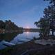 Evening/moonrise over calm lake with multiple docks visible — good scenic overview of the resort shoreline and dock layout (used on homepage).