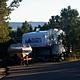 RV Trailer and boat parked in a camping site spur.