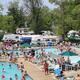 Wide pool and surrounding RV parking/campsite area from an elevated angle — provides an overview of pool and adjacent RV/campsite density; used in the site's gallery/hero images.