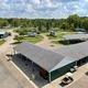 High, wide view showing covered pavilion/structures, multiple RV sites, roads and landscaping — useful overall layout/amenity overview (Amenities page context).