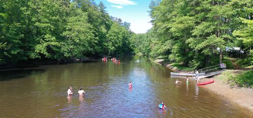 Riverside beach and people in the water