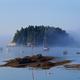 Scenic bay image with small island and moored boats (Five Islands image on site) — shows local waterfront scenery and boating activity visible from the campground.