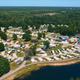 Aerial overview of the property showing RV sites, roads, shoreline and the waterpark area — clearly depicts the campground layout and on-site lake (sourced from the resort home page).