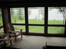 Screened porch view overlooking the lake — from the Rentals page, demonstrates lakeside setting and view from accommodations.