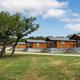 Wide exterior shot of multiple cabins with grounds in front, useful to show cabin cluster and site landscaping (image appears on the About Us / cabins pages).