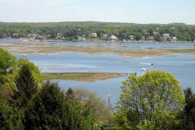 Wide coastal/marsh view across the bay that complements the waterfront shots; hosted on the property site’s Features page (cape-ann-camp-photo2A.jpg) and illustrates nearby water scenery visible from the campground.