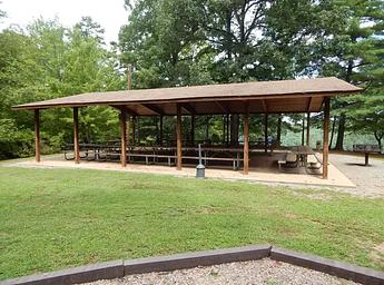 Covered shelter with tables and barbeque.