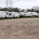 A row of caravans are parked in a warehouse.