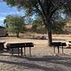 Picnic tables, grills and a pit toilet at the central area of the Calabasas campground.
