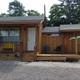 Front-facing cabin photo showing a typical cottage unit and porch — useful to illustrate cabin lodging available on-site (image appears in property photos).