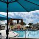 Olympic sized heated swimming pool with palm trees and blue sky background at Hawaiian Isles RV Reso