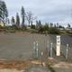 Empty prepared RV lot with utility hookups visible — useful to show available RV pad infrastructure advertised on the site (RV lot listing).