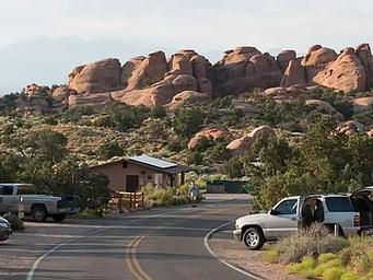 Campground road lined with campsites and boulders in the background.