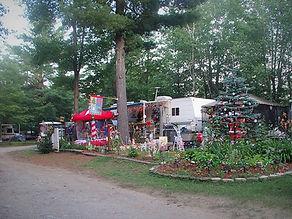 RV/trailer campsite with site decorations and landscaping — illustrates the appearance of campsites and lot layout; appears on the site's About Us page.